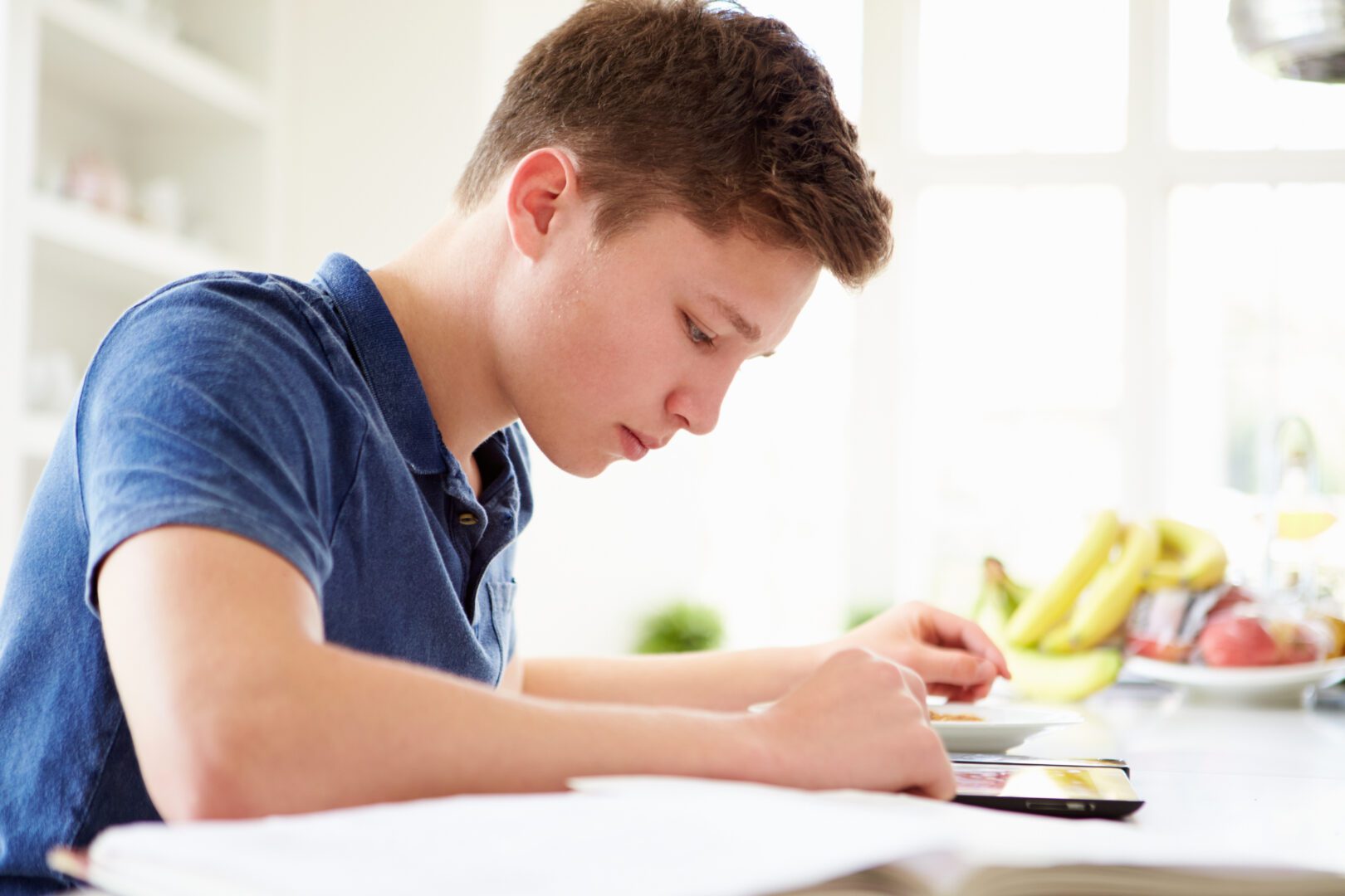 Teenage Boy Studying For A Test At Home