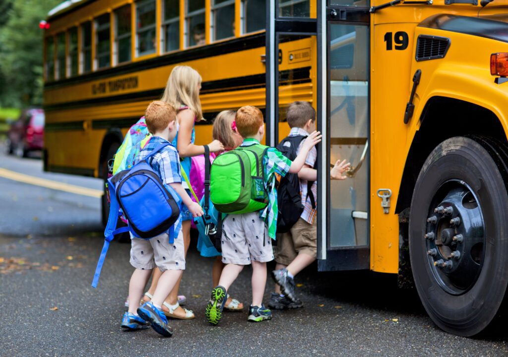 children getting on a school bus