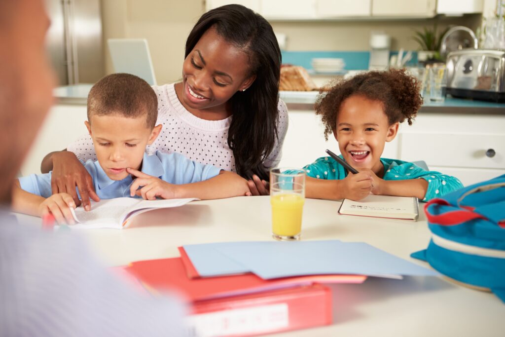 Mother helping her children do homework.