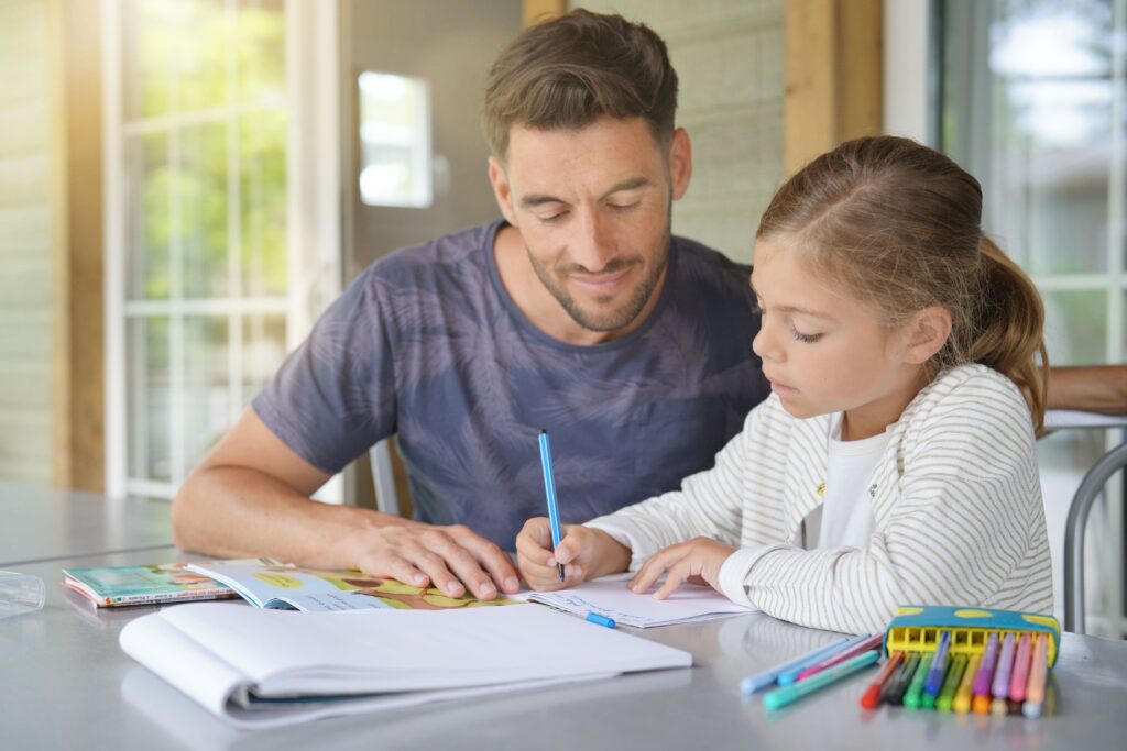 Father helping young student with homework.